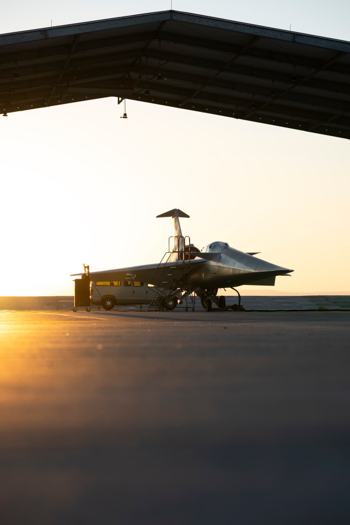 NASA's X-59 three-quarter view of the aircraft while it sits in a run stall at sunrise.