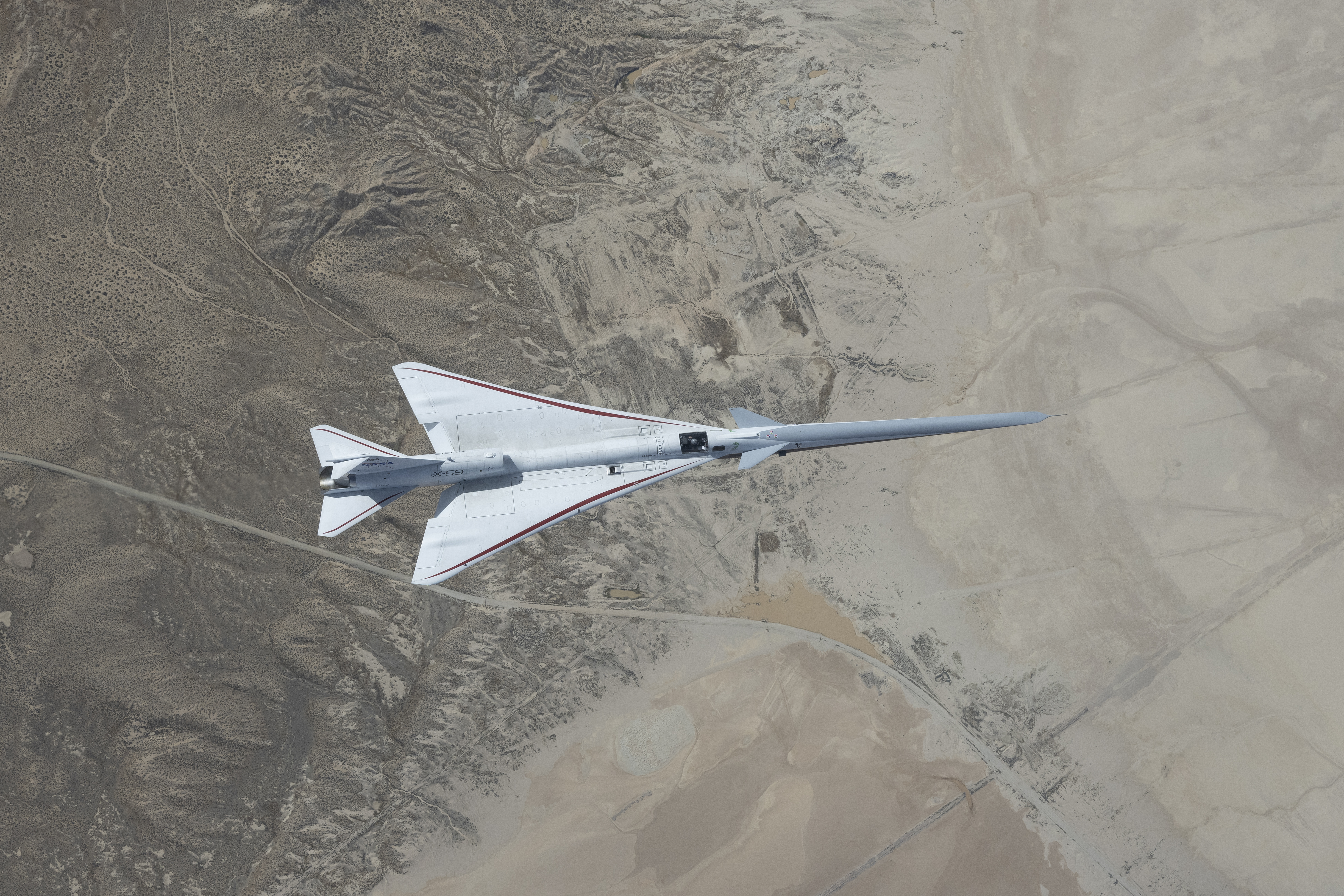 Bird's eye view of the X-59 in flight over the Mojave Desert.