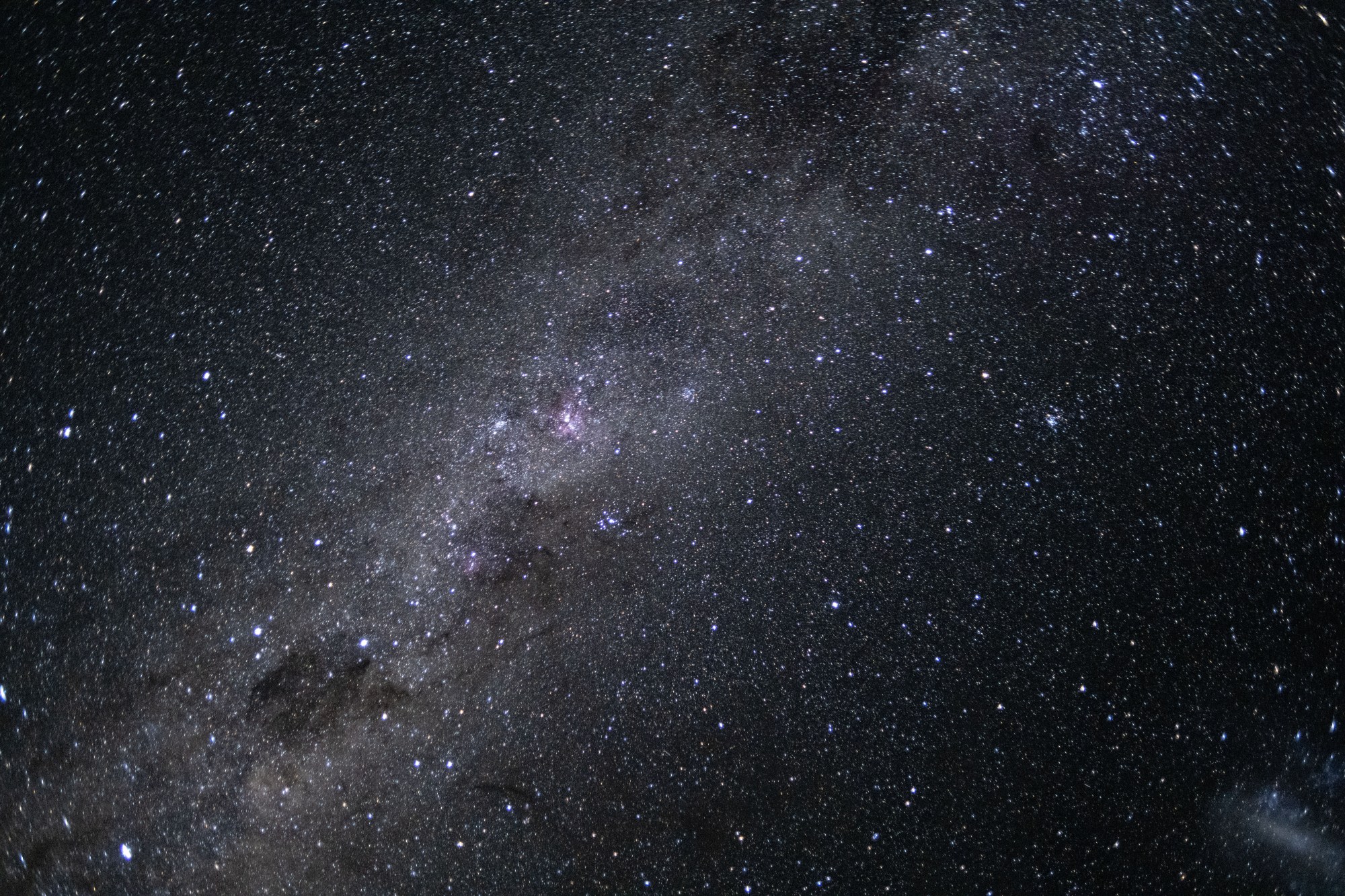 The Milky Way galaxy appears as many points of light dotting the blackness of space.