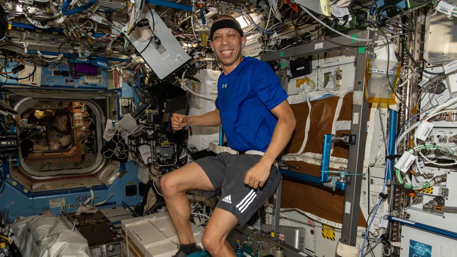 NASA astronaut and Expedition 74 flight engineer Chris Williams pedals on the exercise cycle inside the International Space Station’s Destiny laboratory module. Astronauts work out daily on the exercise cycle to maintain muscle, bone, and cardiovascular health in microgravity.