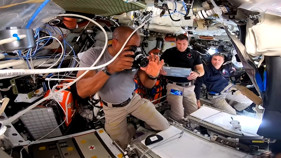 Victor Glover, Jeremy Hansen, and Reid Wiseman work together inside the Orion spacecraft on their way to the Moon.
