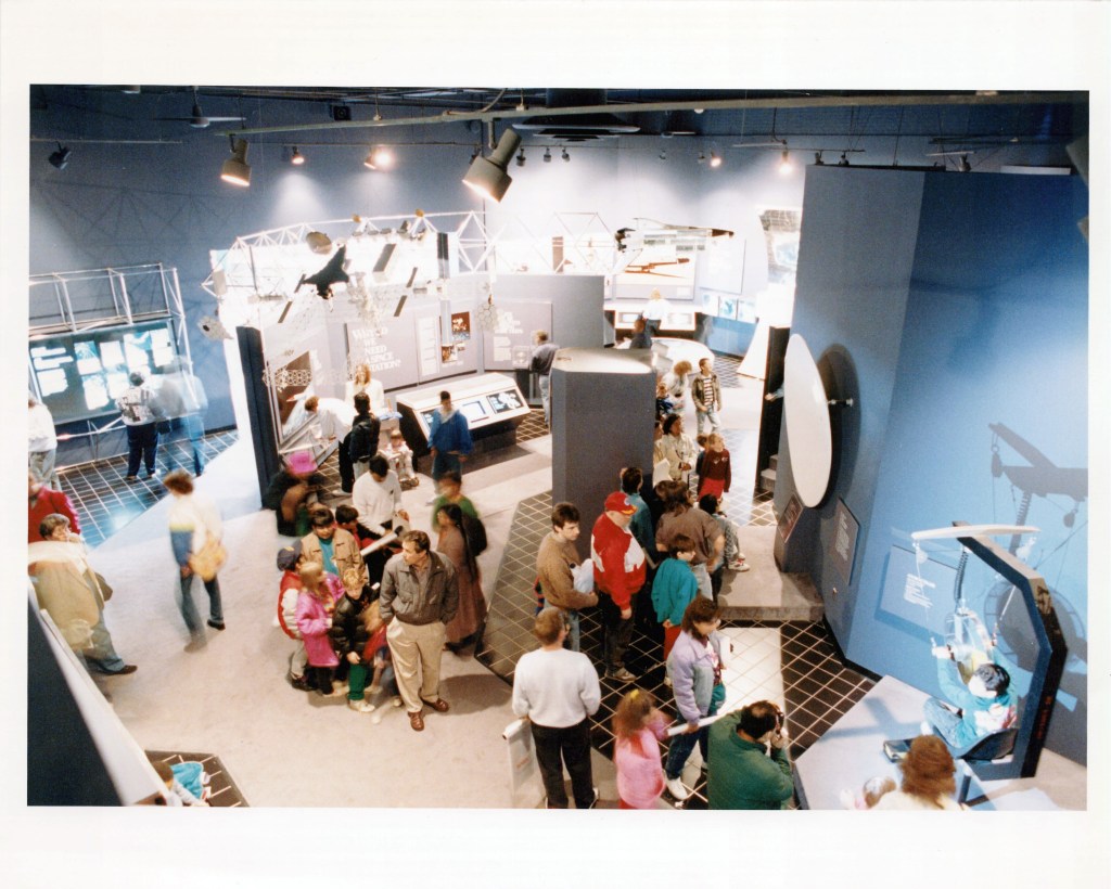 seen from above, a crowd of people in the main space of the NASA Goddard Visitor Center