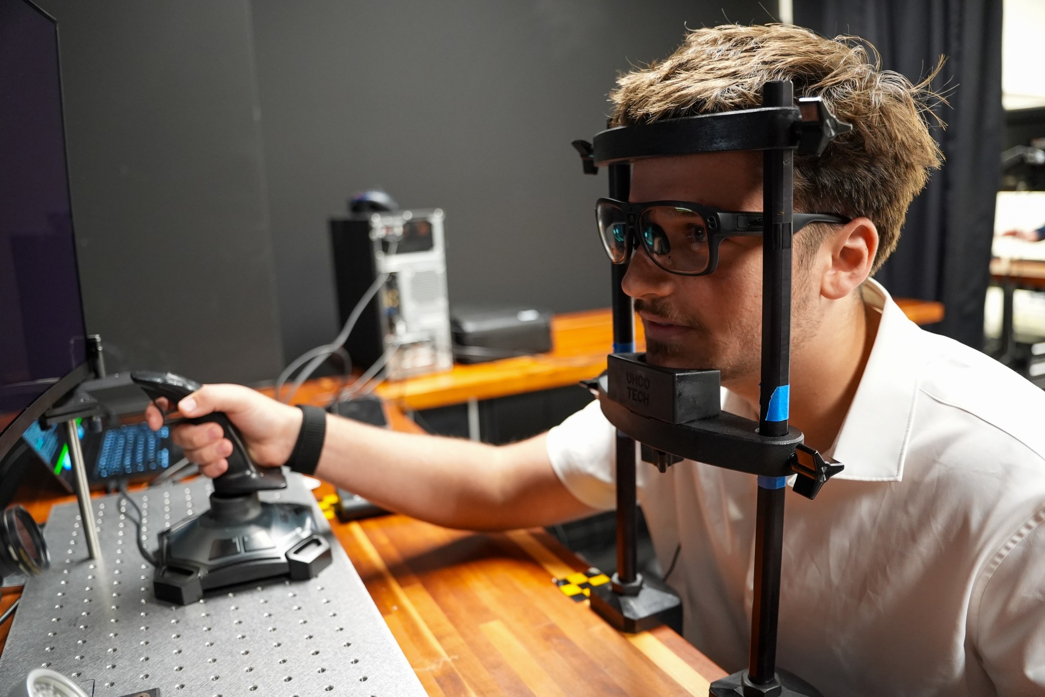 A participant completes a lunar landing simulation in the Human Perception and Performance Laboratory (HPPL) at NASA Ames Research Center while wearing eye-tracking glasses to help researchers model human performance for upcoming missions to the Moon