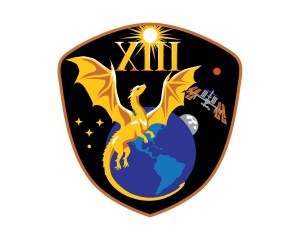 jsc2026e006908 (Feb, 11, 2026) --- NASA’s SpaceX Crew-13 patch looks ardently toward the future of space exploration while honoring the legacy of those who came before. The central golden dragon harkens back to Apollo 13, embodying resilience and gazing upward to the dawn of a new era of discovery. The tail contours around Earth in an embrace, highlighting the interconnected nature of human spaceflight and celebrating the collective efforts of the teams who make it possible. The wings, outstretched to form a bridge between Earth, the International Space Station, the Moon, and Mars, reflect the continuity between low Earth orbit and destinations to come. Gold stars burn brightly, representing the crew’s families and support systems as a tribute to their immense contributions to this endeavor. All of these themes are unified within a distinctive capsule silhouette, symbolizing the limitless possibilities born out of human collaboration toward a common goal. Credit: NASA