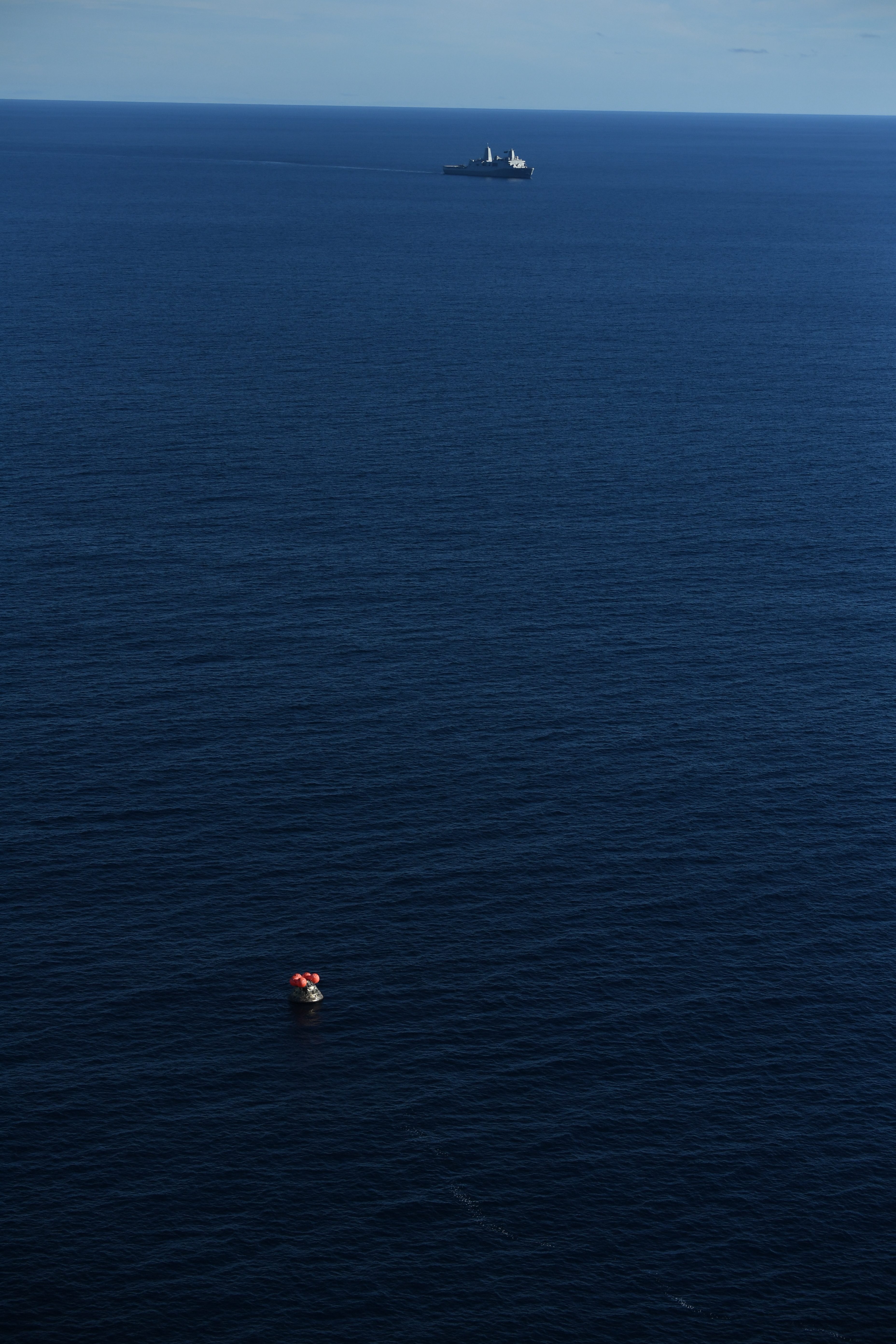USS John P. Murtha approaches NASA's Orion spacecraft carrying Artemis II Commander Reid Wiseman, Pilot Victor Glover, and Mission Specialist...