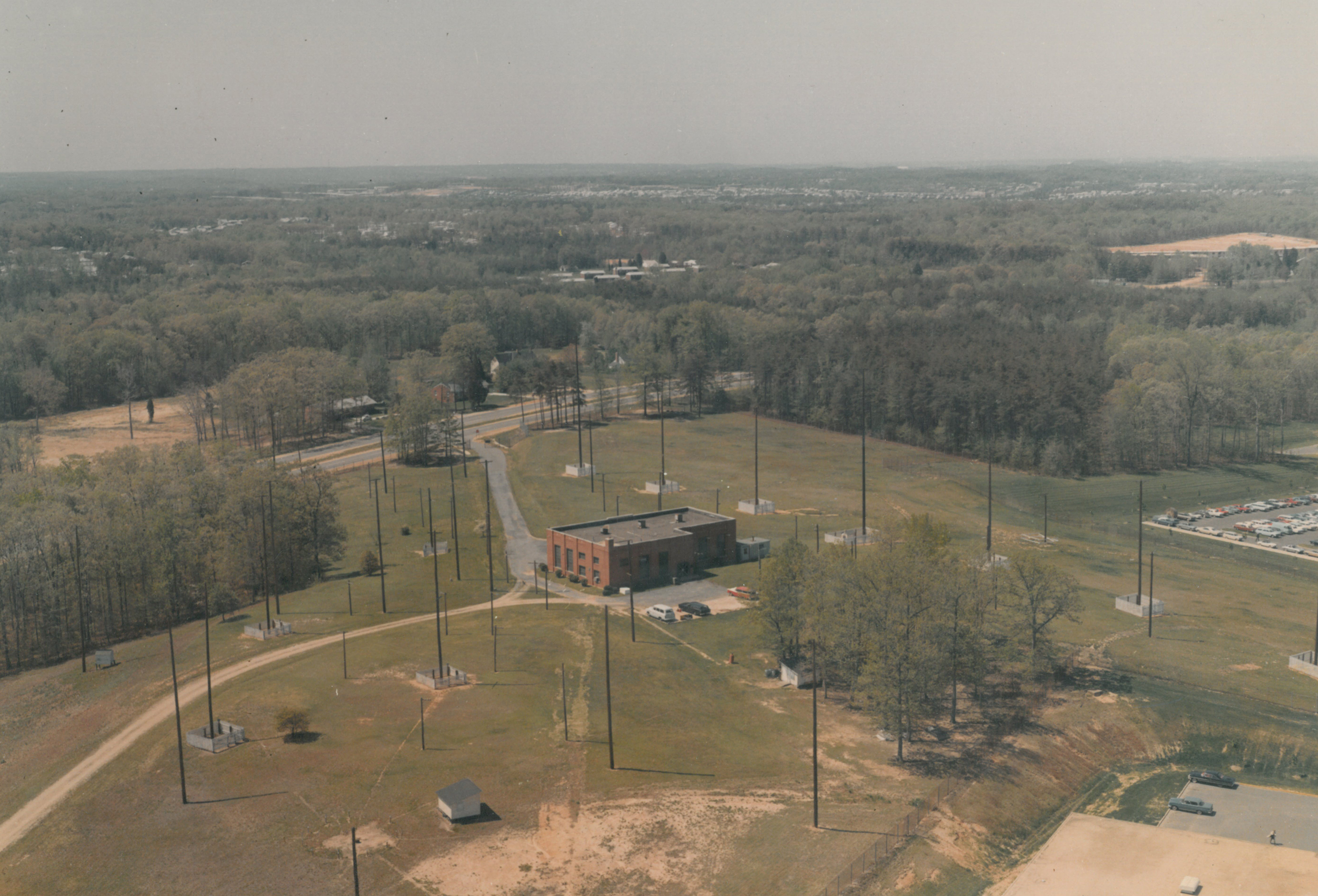 red brick building on a hill surrounded by tall antennae structures