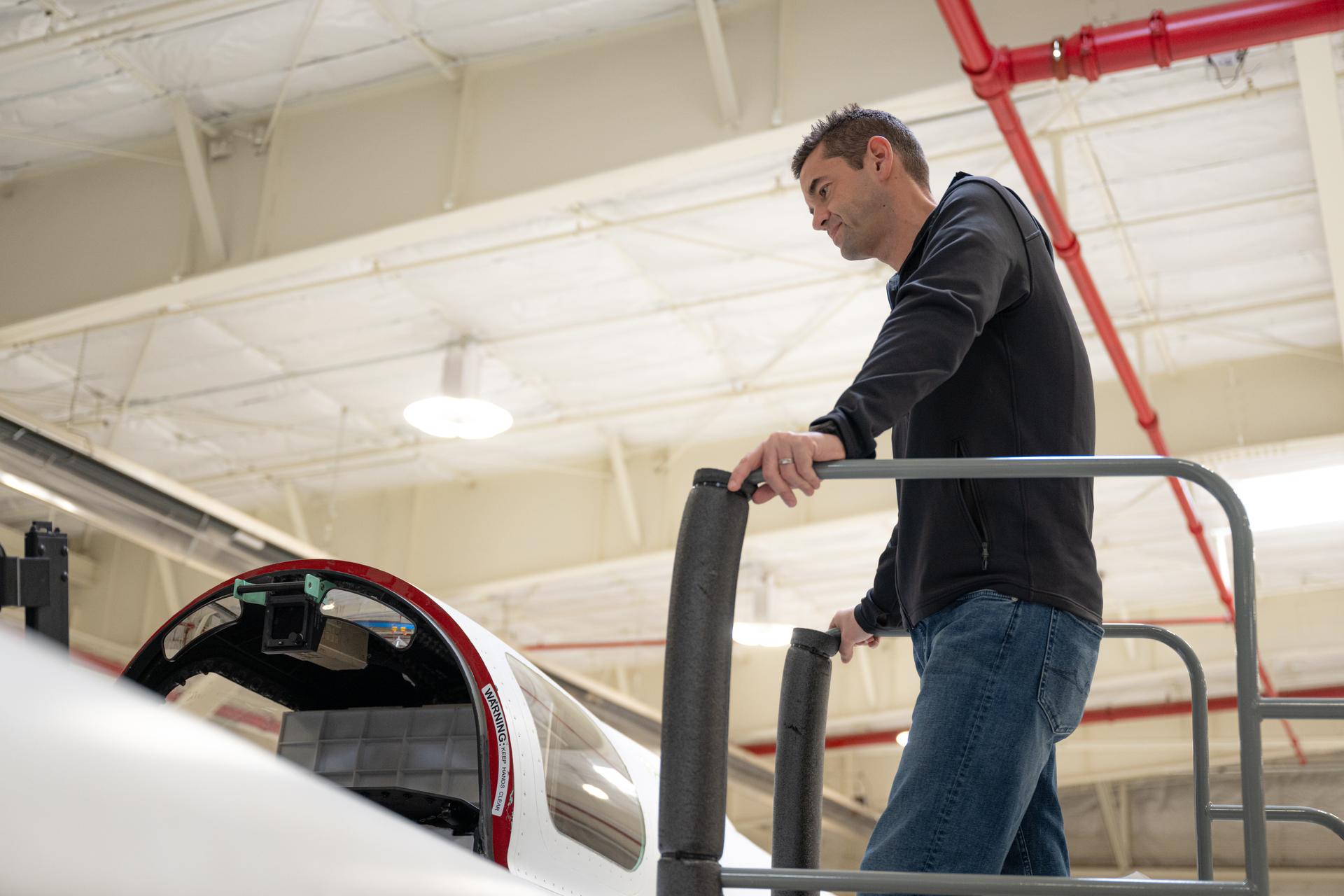 NASA Administrator Jared Isaacman looking into the X-59 cockpit.