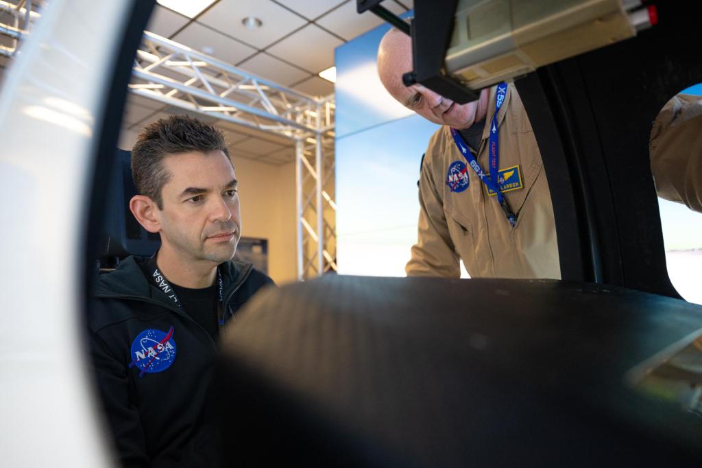 NASA Administrator Jared Isaacman, left, is seen inside the X-59 flight simulator alongside Nils Larson, NASA pilot.