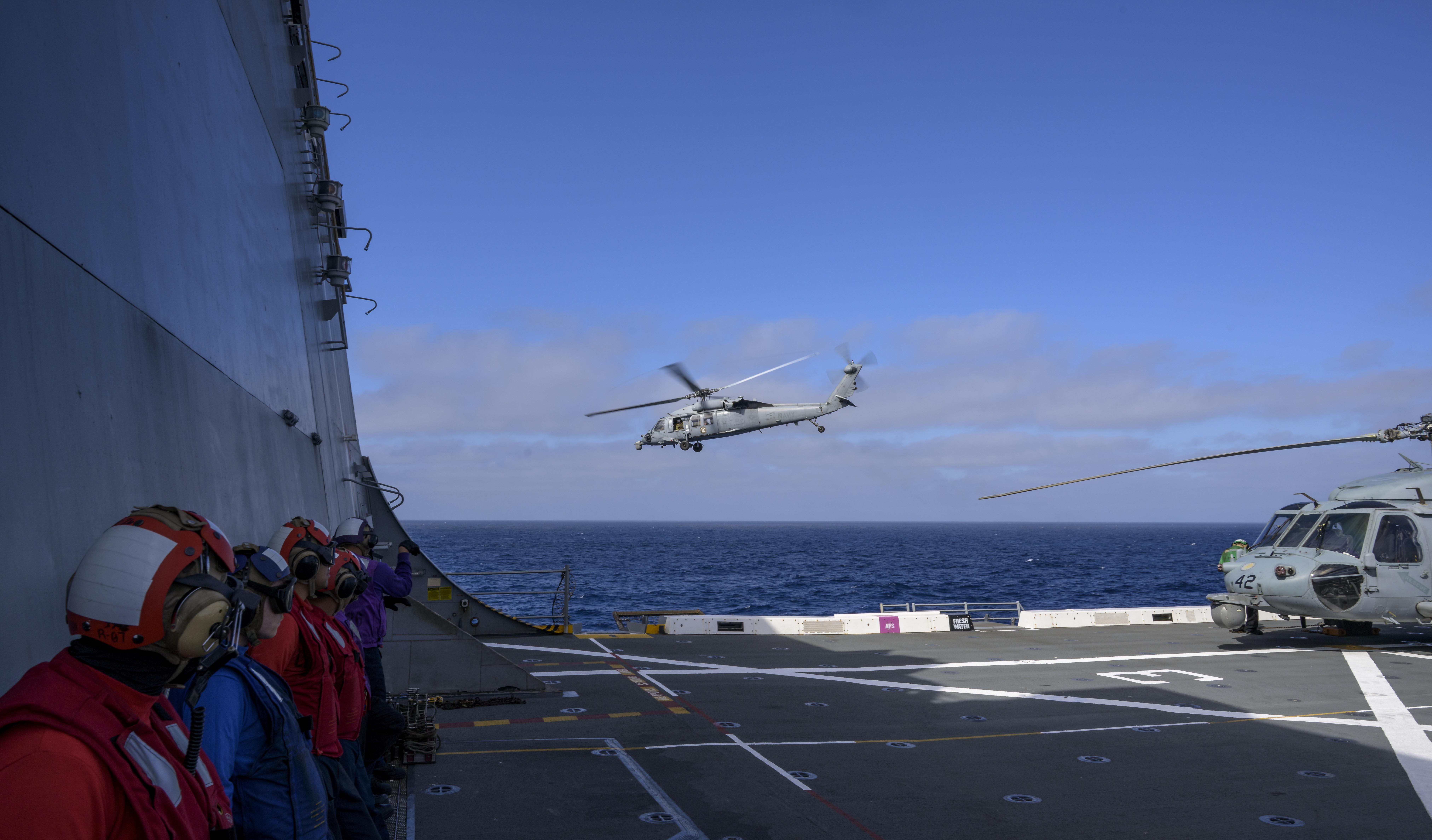 U.S. Navy MH-60 Seahawks from Helicopter Sea Combat Squadron (HSC) 23 depart USS John P. Murtha as they conduct air...