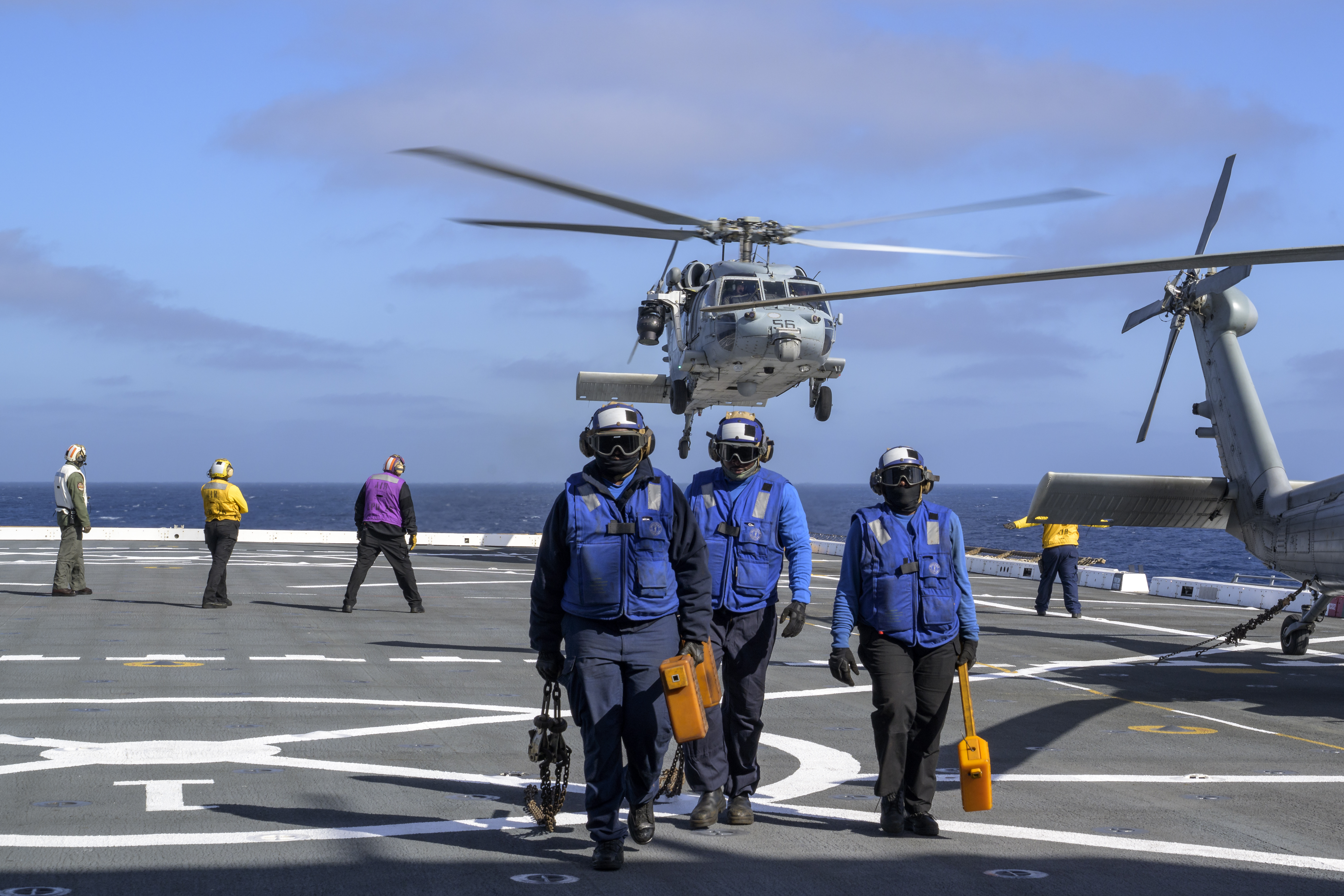 U.S. Navy MH-60 Seahawks from Helicopter Sea Combat Squadron (HSC) 23 depart USS John P. Murtha as they conduct air...