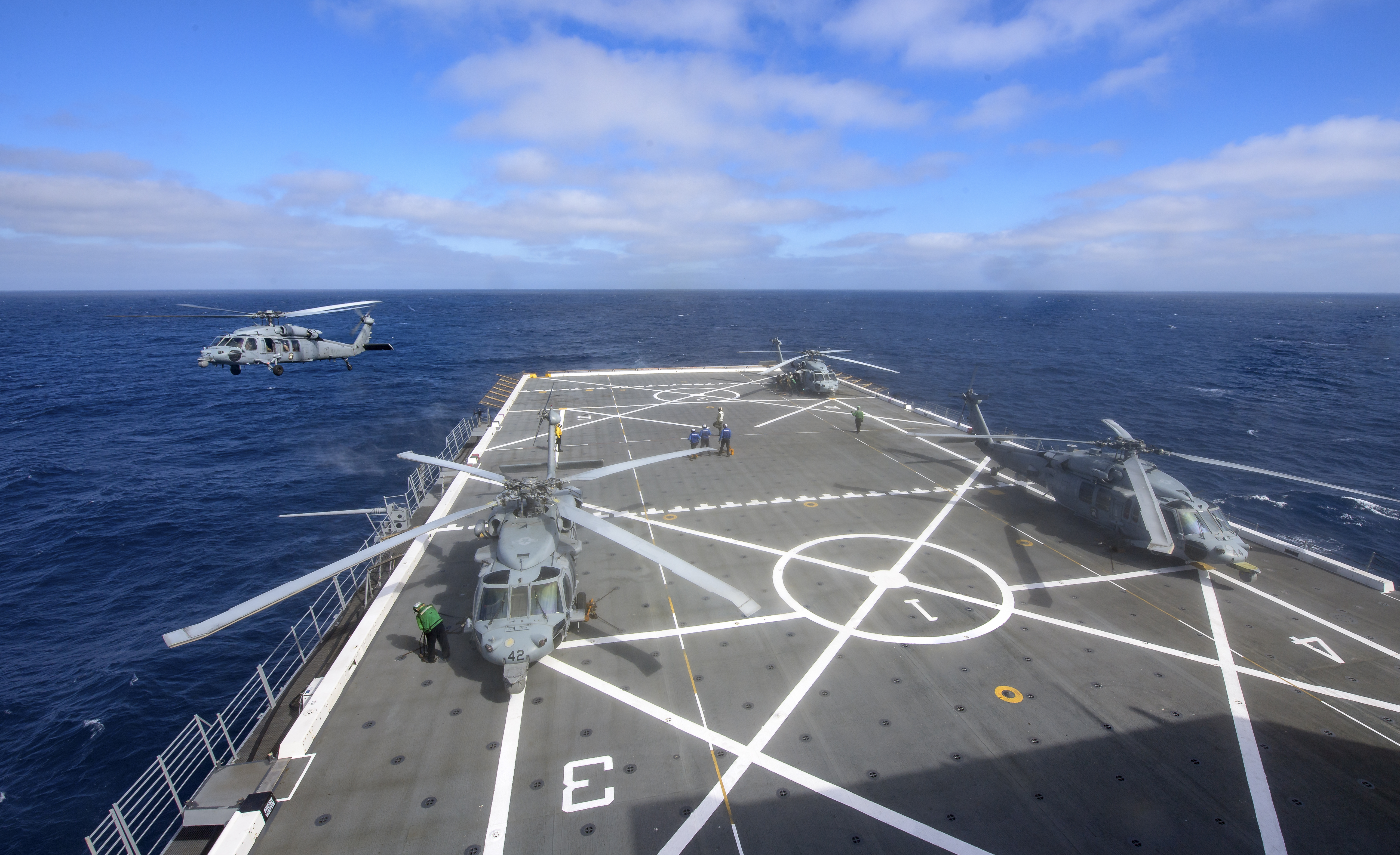 U.S. Navy MH-60 Seahawks from Helicopter Sea Combat Squadron (HSC) 23 on USS John P. Murtha prepare to conduct air...