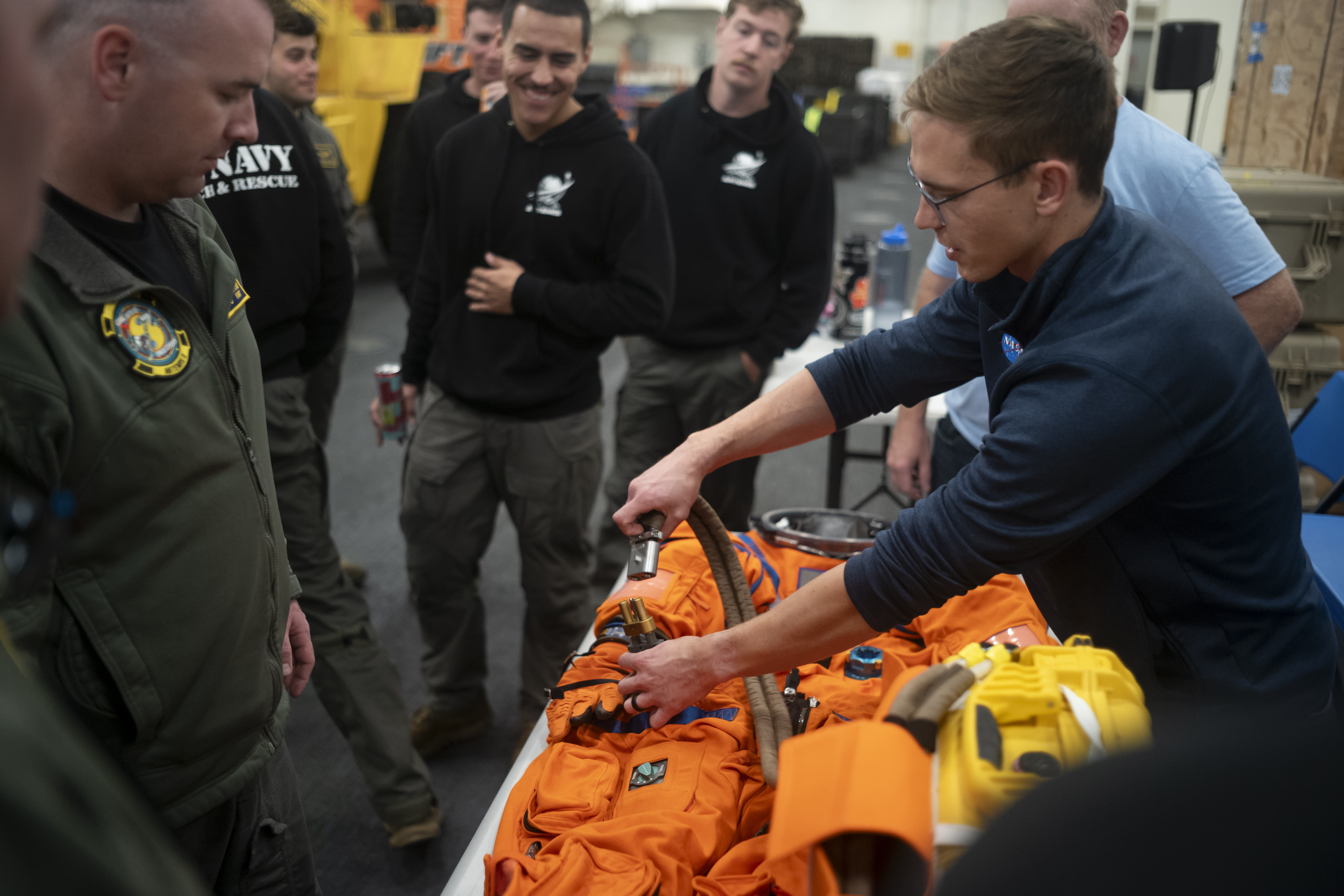 Nicholas Houghton, an Orion Crew Survival System engineer at NASA’s Johnson Space Center, left, conducts familiarization training with the Orion...