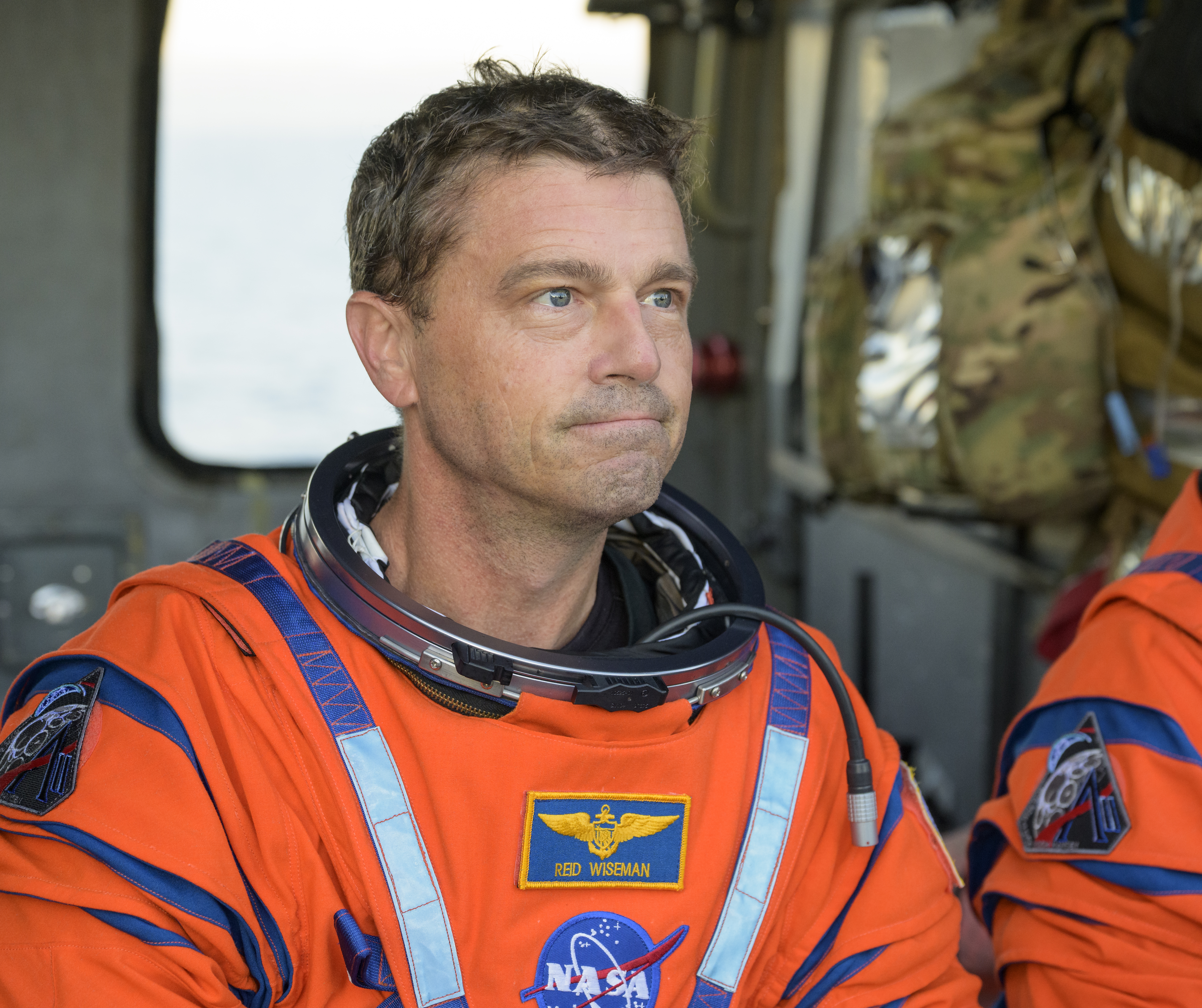 NASA astronaut Reid Wiseman, Artemis II commander is seen sitting in a Navy MH-60 Seahawk from Helicopter Sea Combat Squadron...