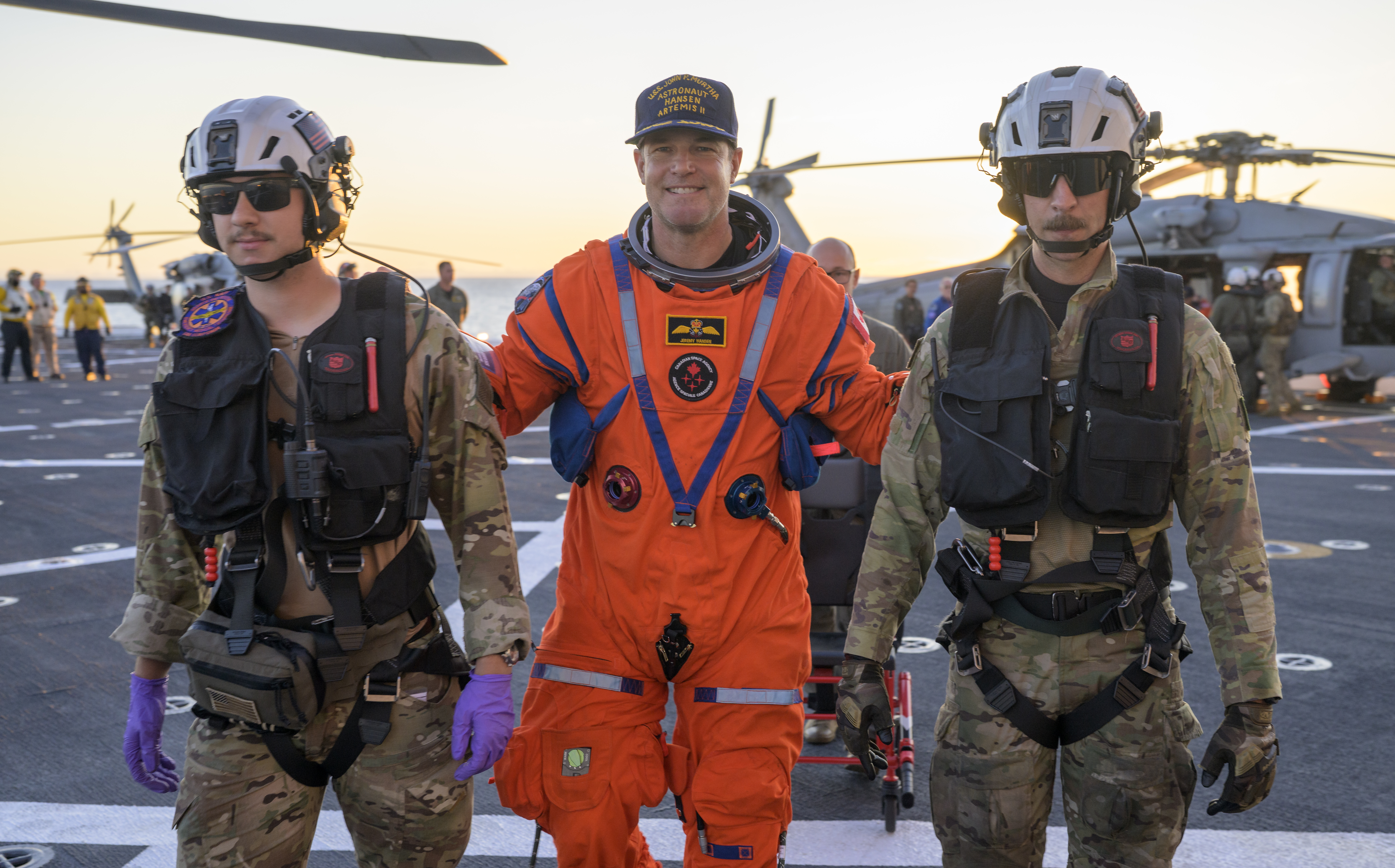 CSA (Canadian Space Agency) astronaut Jeremy Hansen, Artemis II mission specialist is assisted off the flight deck after arriving aboard...