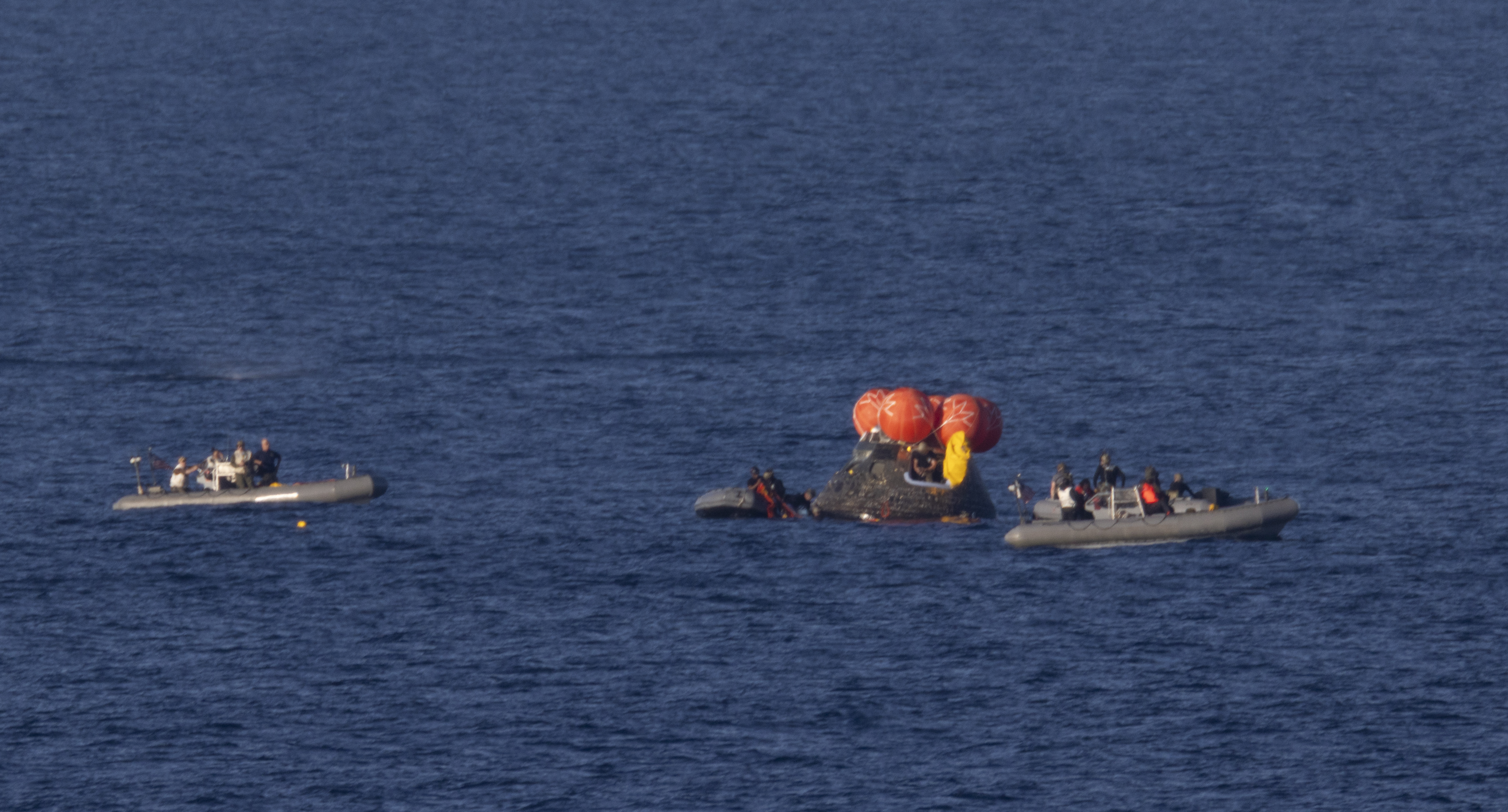 NASA’s Orion spacecraft is seen as recovery teams work to secure the spacecraft ahead of transferring Artemis II crewmembers NASA...