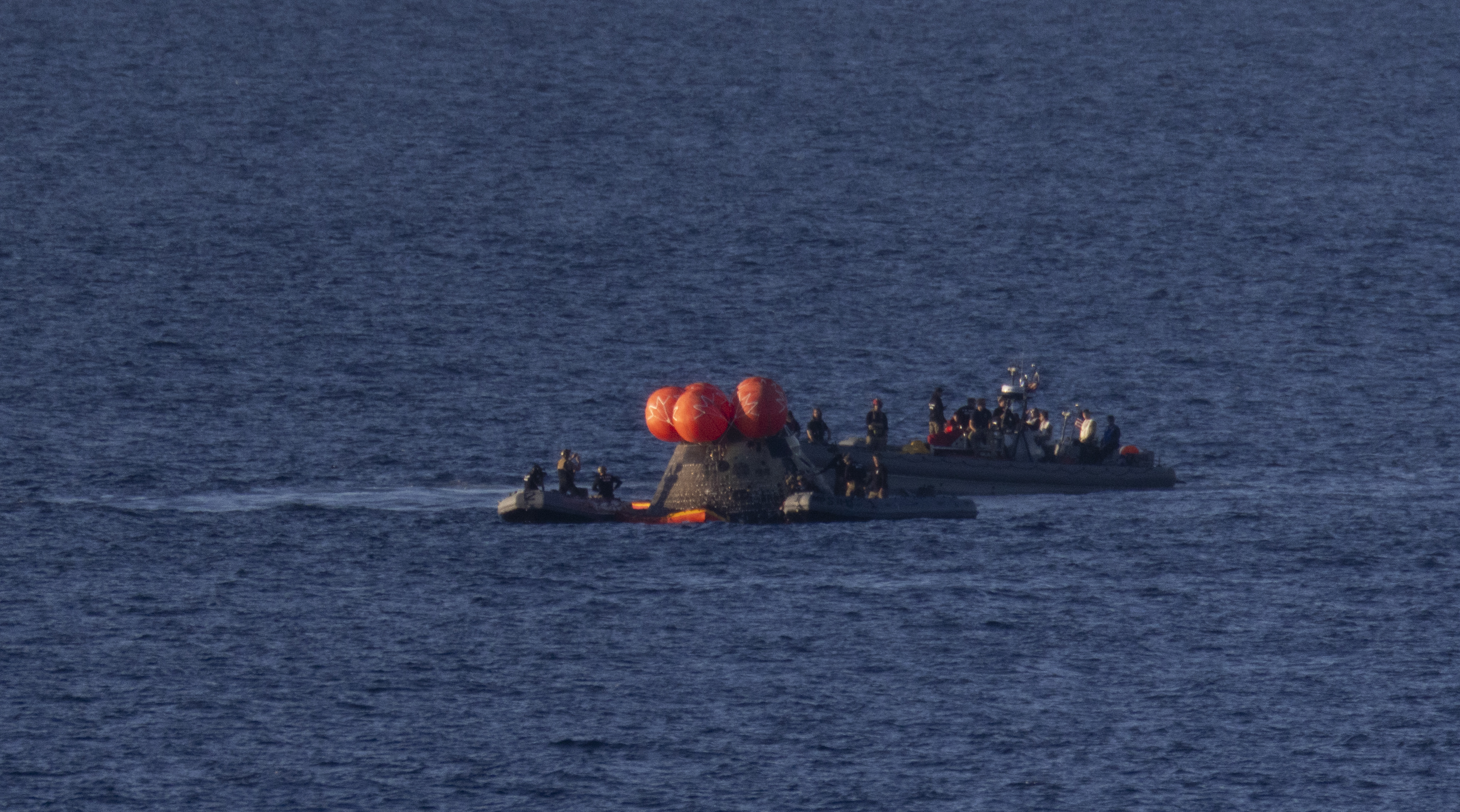 NASA’s Orion spacecraft is seen as recovery teams work to secure the spacecraft ahead of transferring Artemis II crewmembers NASA...