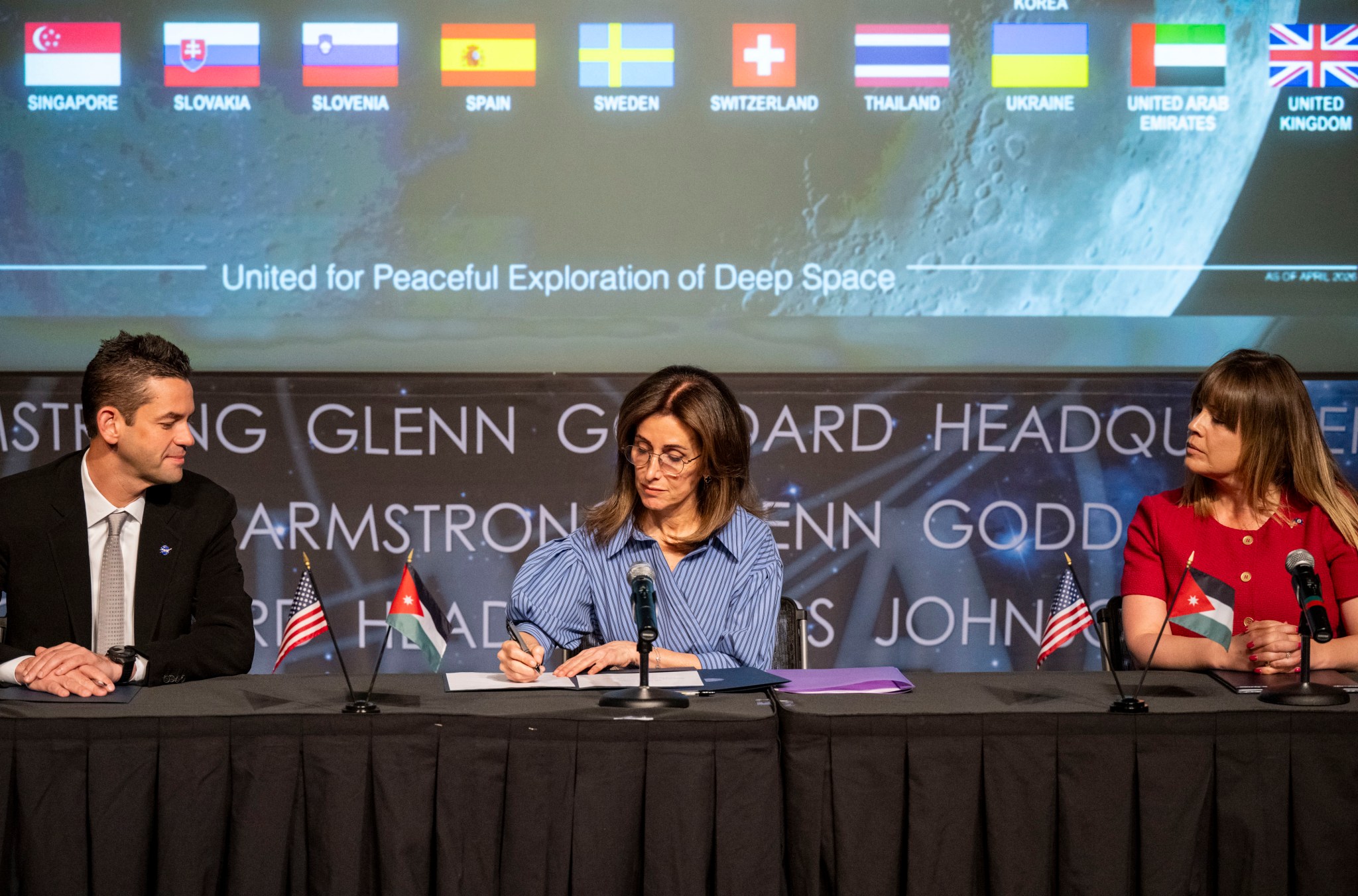 Ambassador of the Hashemite Kingdom of Jordan to the United States Dina Kawar, center, signs the Artemis Accords alongside NASA Administrator Jared Isaacman, left, and U.S. Department of State Acting Principal Deputy Assistant Secretary of State for Oceans and International Environmental and Scientific Affairs Ruth Perry, right, Thursday, April 23, 2026, at the Mary W. Jackson NASA Headquarters building in Washington. 