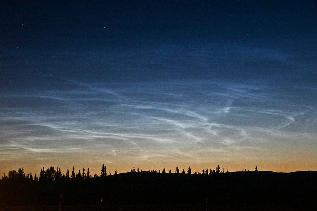 Noctilucent clouds or "night-shining" clouds, are rare, electric-blue, wispy clouds formed of water ice crystals in the mesosphere, about 50 miles (80-85km) above Earth