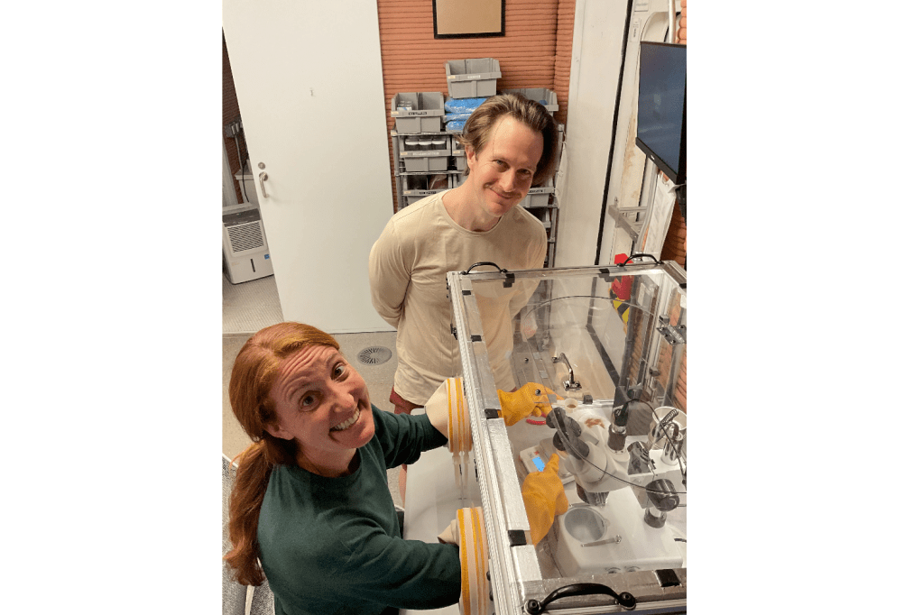 Crew Health and Performance Exploration Analog (CHAPEA) Mission 2 crew members use the glove box inside the habitat. (From left: Ellen Ellis, Matthew Montgomery)