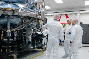 NASA Moon Base program leaders in clean-room attire examine Astrobotic’s Griffin-1 lunar lander inside the company’s facility in Pittsburgh, Pennsylvania. One person gestures toward the lander.
