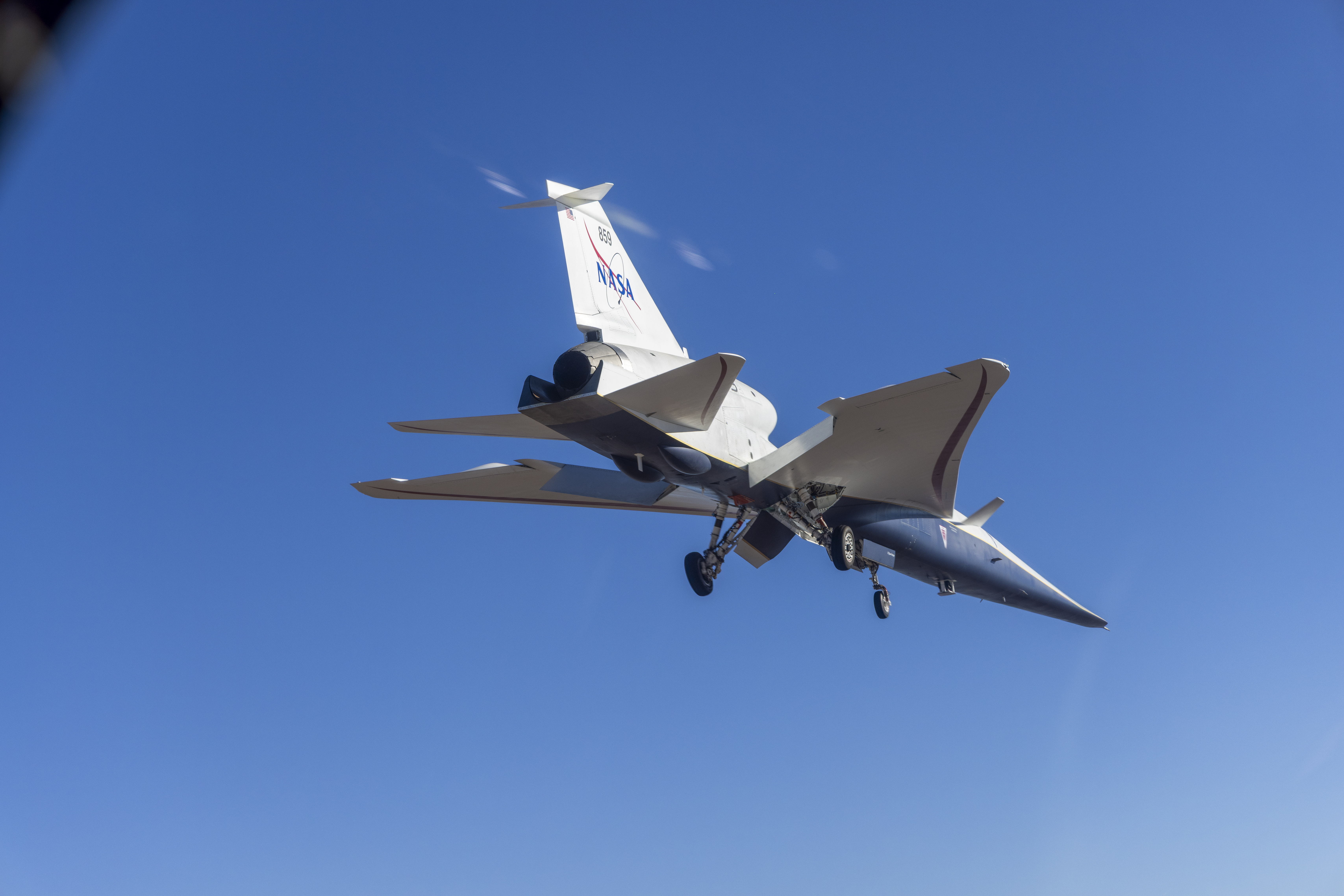 Bottom view of the X-59 aircraft while it's in flight.