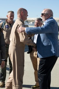 Bob Pearce greeting NASA test pilot Nils Larson with a handshake.