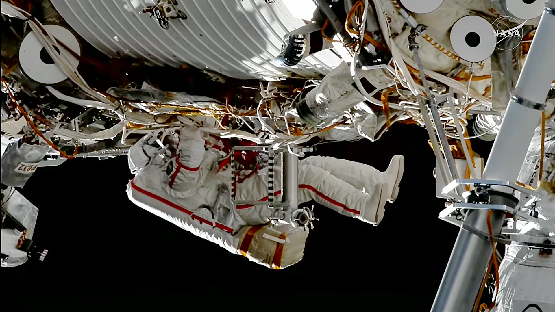 Roscosmos cosmonaut Sergey Ku-Sverchkov installs a solar radiation experiment during a spacewalk on the outside of the International Space Station.