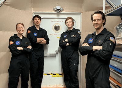 Members of NASA’s CHAPEA (Crew Health and Performance Exploration Analog) mission 2 pose for a group photo. (From left to right: Ellen Ellis, Ross Elder, James Spicer, Matthew Montgomery)