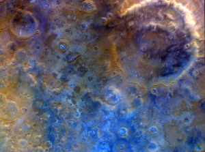 In this representative color image, Mars' surface appears in shades of red, orange, and blue. At right is a double-ring crater called Huygens. To