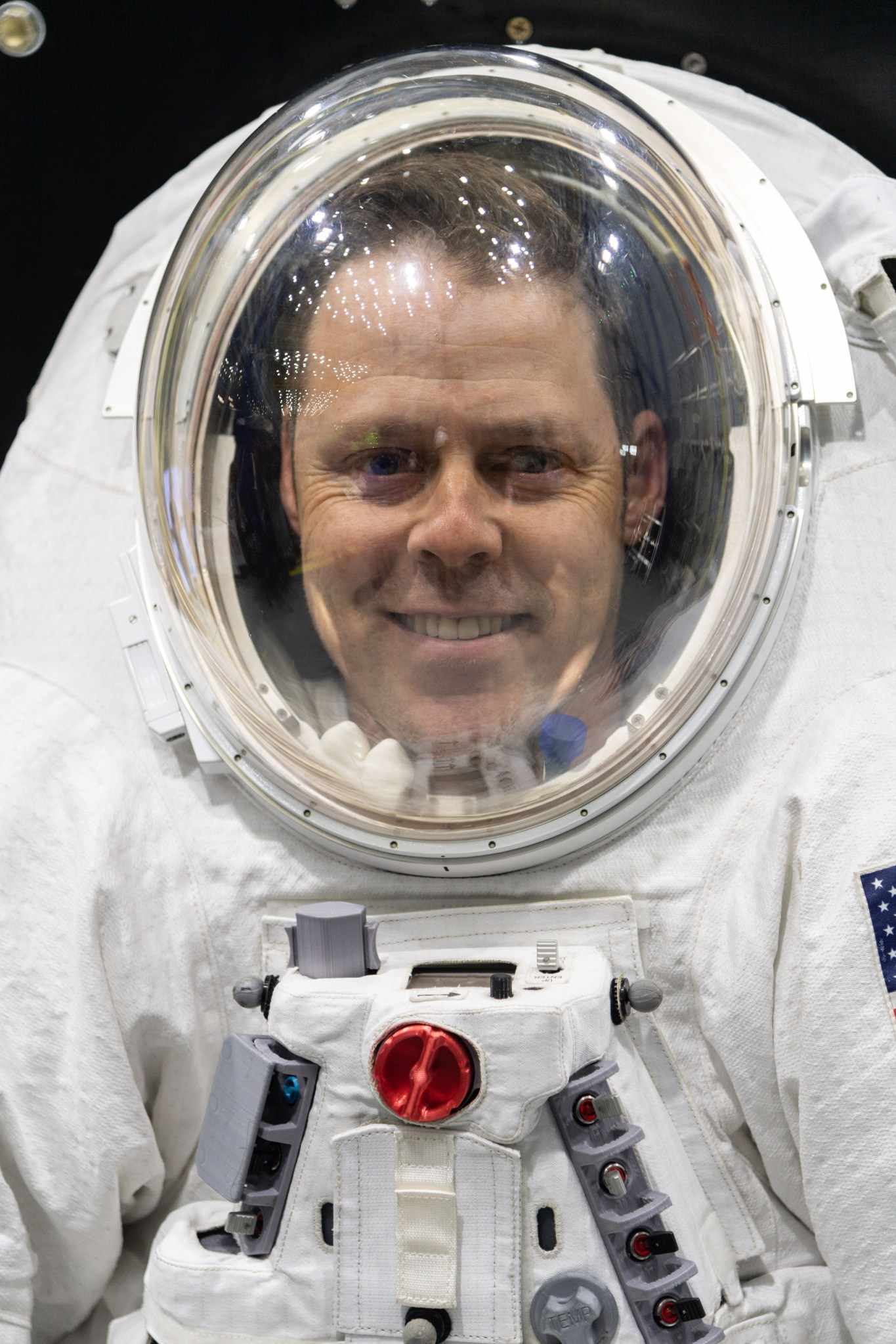 Scott Wray smiles from inside NASA’s Exploration Extravehicular Mobility Unit.