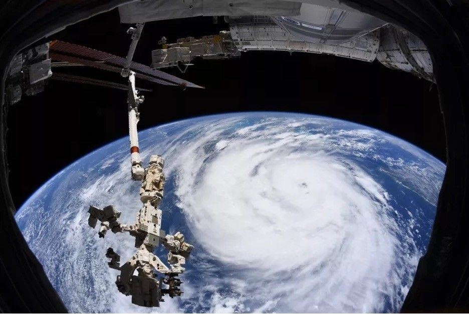 Hurricane Ida is pictured as a category 2 storm from the International Space Station as it orbited 264 miles above the Gulf of Mexico. In the foreground is the Canadarm2 robotic arm with Dextre, the fine-tuned robotic hand, attached.