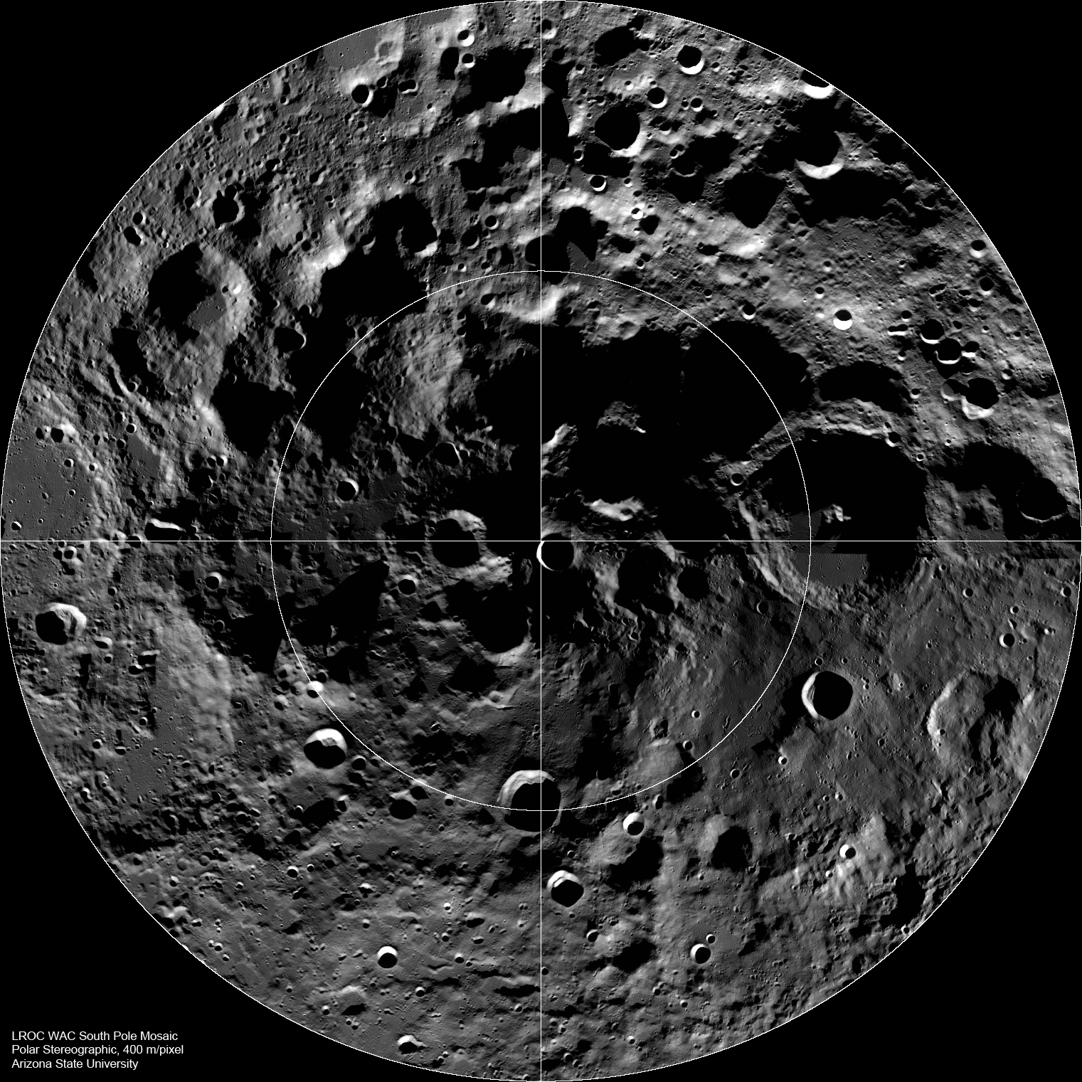 Black-and-white mosaic of the Moon’s South Pole showing a densely cratered landscape viewed from above. Circular grid lines and crosshairs overlay the image, with the lunar pole located at the center. Large and small craters cover the region, with deep shadows visible inside many crater walls and basins.