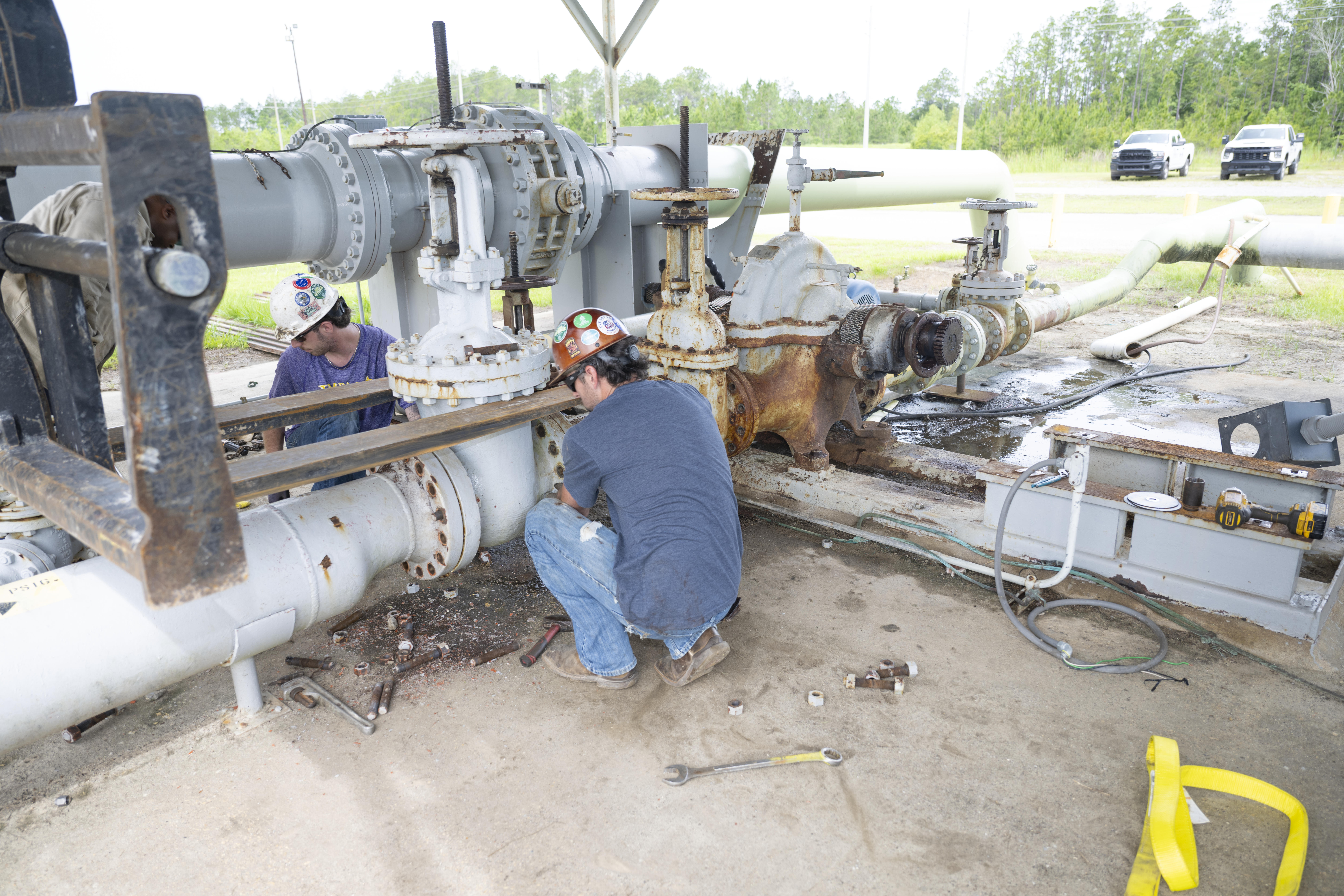 A work crew on a lift removes the main isolation valve at the High Pressure Industrial Water Facility on May 11 as part of pump replacement and upgrade work.