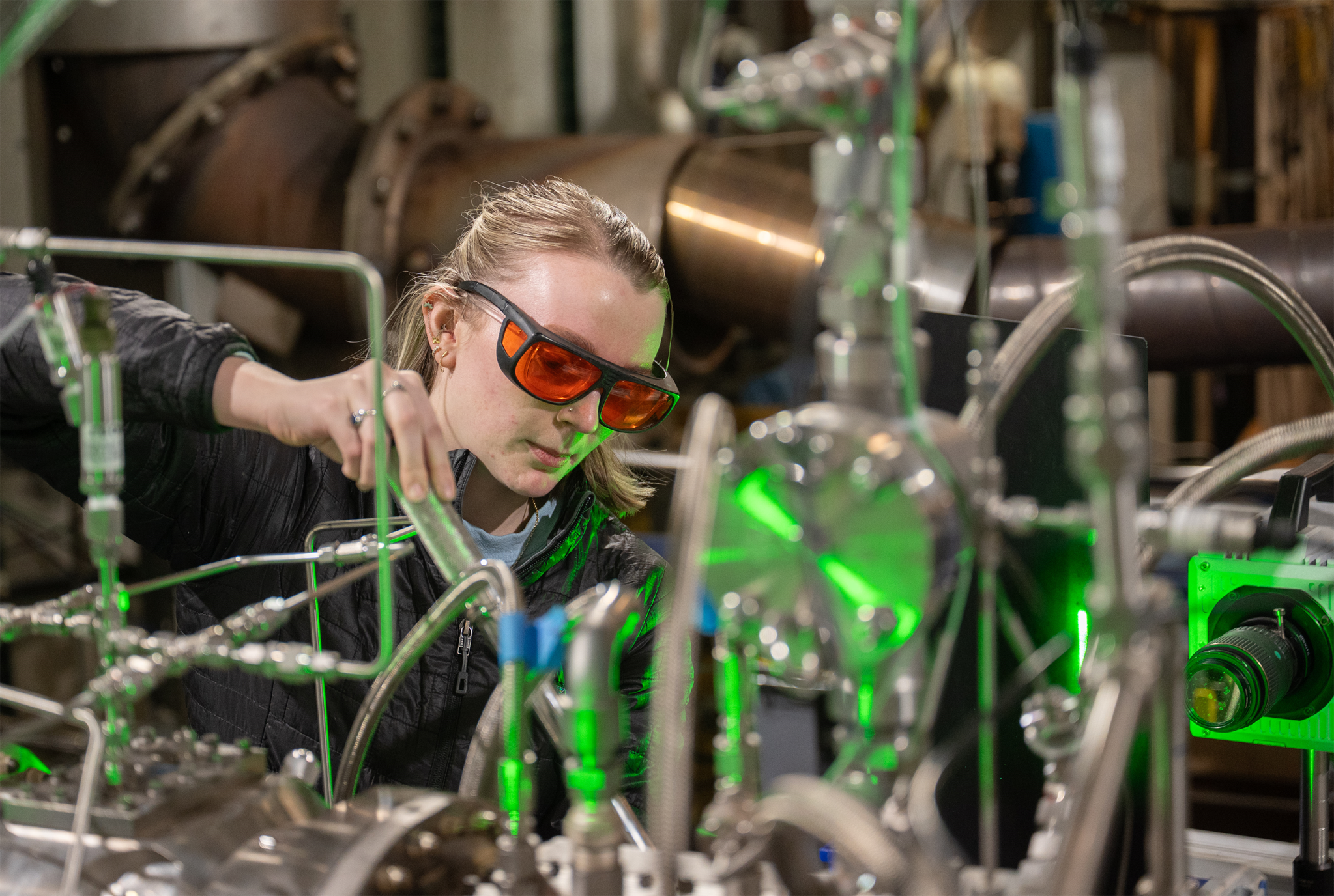 A ULI Student at Georgia Tech working on a research project wearing goggles inside the lab.