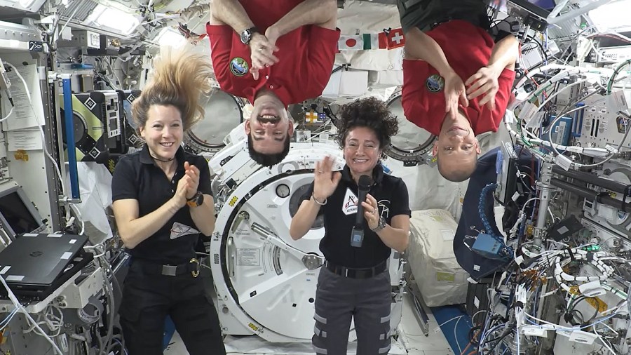 Expedition 74 crew members (from left) Sophie Adenot, Jack Hathaway, Jessica Meir, and Chris Williams congratulate the Artemis III crew in a recorded video message.