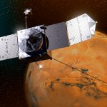 A black and gray spacecraft flies in front of a rust-colored Mars, with deep space in the background.