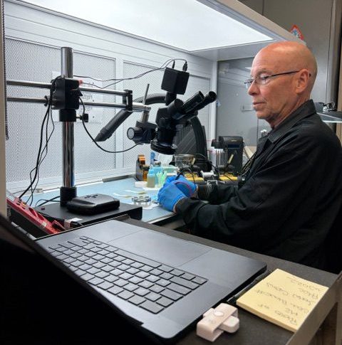 A person sitting at a desk operating equipment