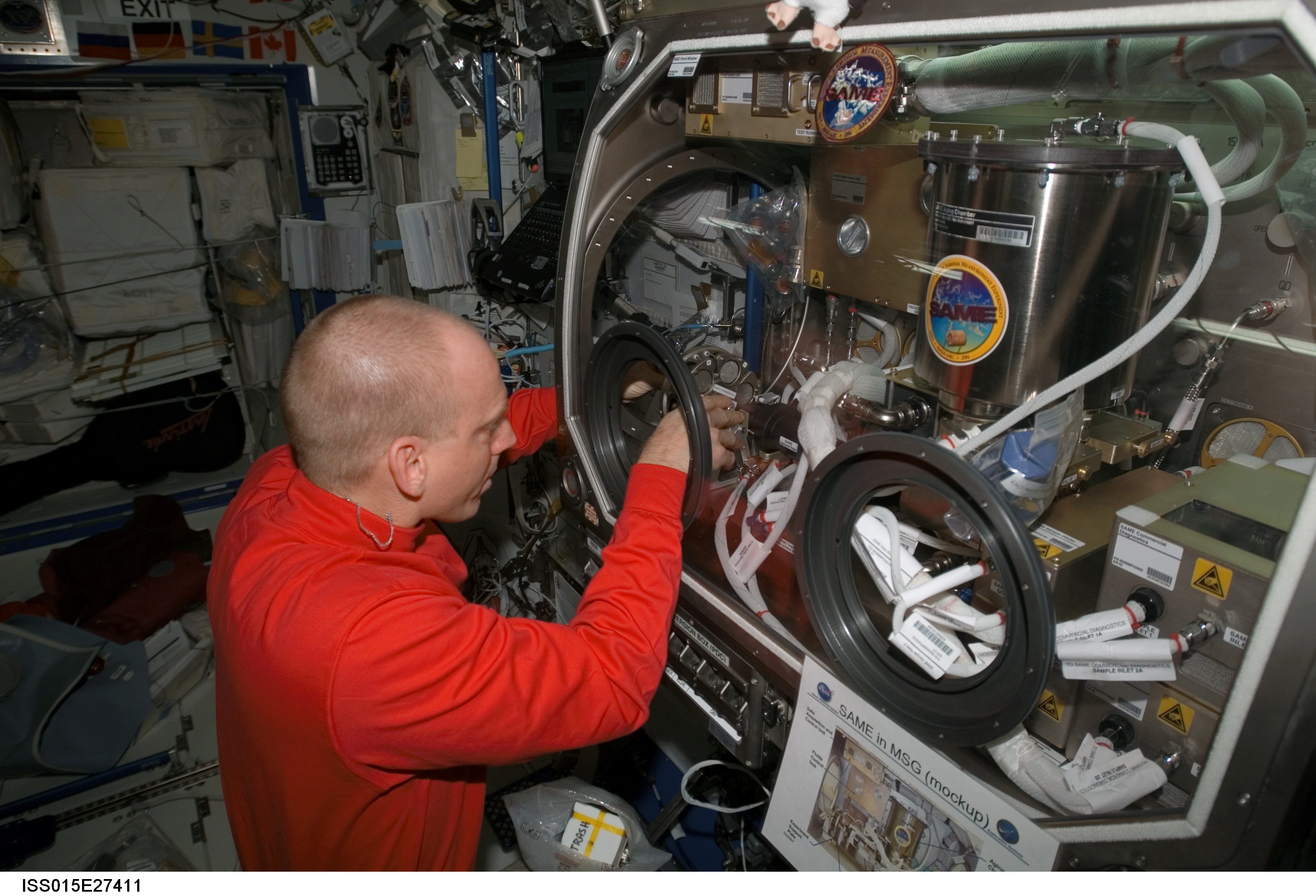 NASA astronaut Clay Anderson, Expedition 15 flight engineer, works on the Smoke and Aerosol Measurement Experiment (SAME) hardware located in the Microgravity Science Glovebox (MSG) in the Destiny laboratory of the International Space Station.