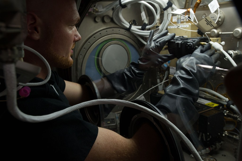 Alexander Gerst conducts two flame tests for the combustion investigation Burning and Suppression of Solids (BASS) in the Microgravity Science Glovebox (MSG) aboard the International Space Station.
