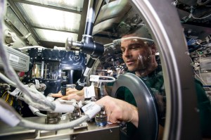 NASA astronaut Reid Wiseman installs Capillary Channel Flow (CCF) experiment hardware in the Microgravity Science Glovebox (MSG) aboard the International Space Station.
