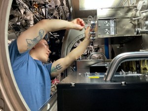 Astronaut Jonny Kim installs the Colloidal Solids hardware in the Microgravity Science Glovebox (MSG)