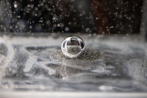 Tiny ball bearings surround a larger central bearing during the Fluid Particles experiment, conducted inside the Microgravity Science Glovebox (MSG) aboard the International Space Station.