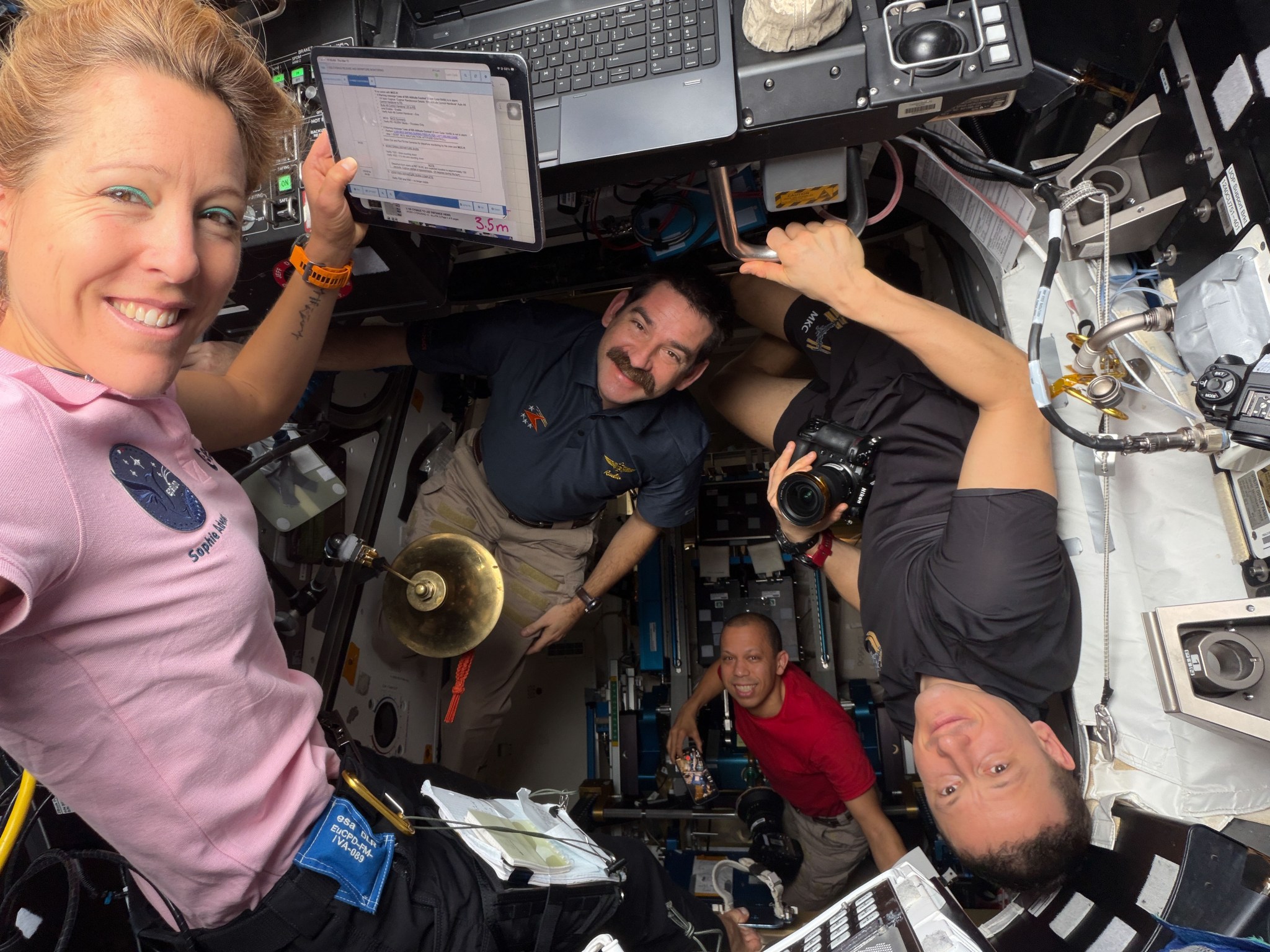 Expedition 74 crew members (from left) Sophie Adenot of ESA (European Space Agency), NASA astronauts Jack Hathaway and Chris Williams, and Roscosmos cosmonaut Sergey Kud‑Sverchkov pose for a portrait together inside the International Space Station’s cupola and Tranquility module.