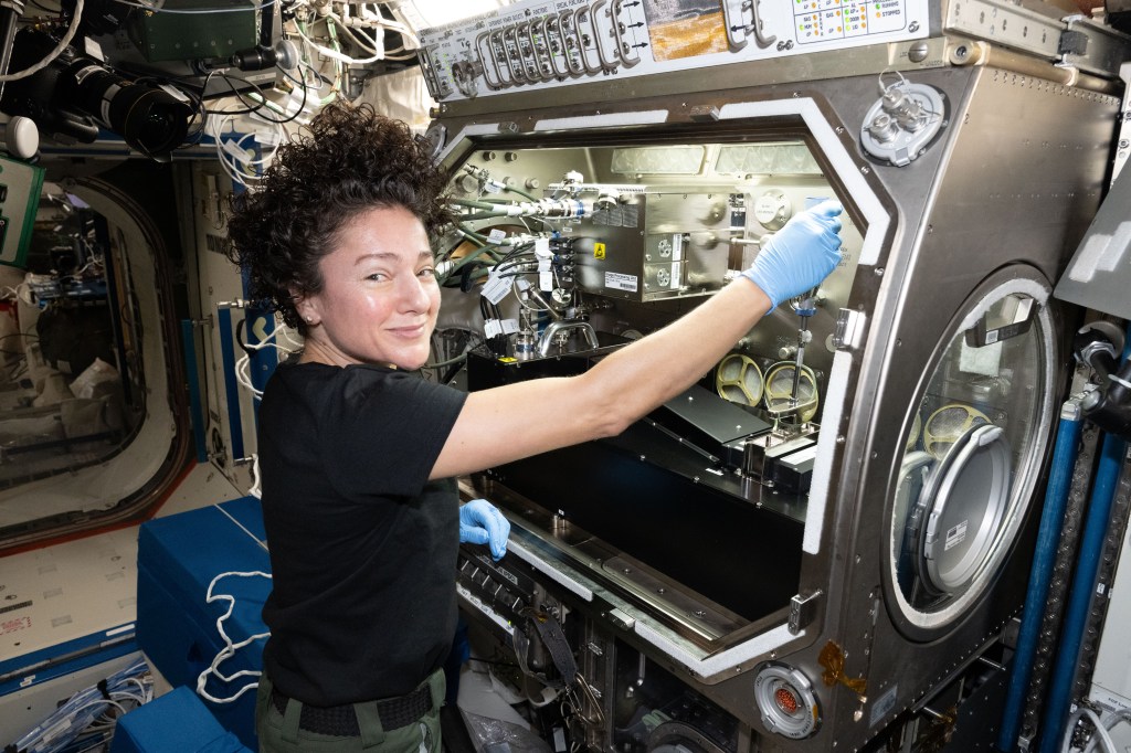 NASA astronaut Jessica Meir configures research gear inside the Microgravity Science Glovebox aboard the International Space Station.