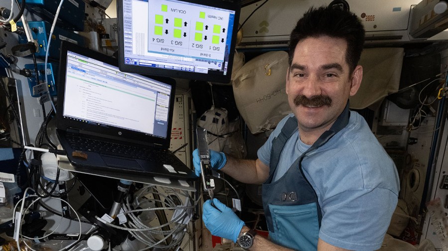 NASA astronaut Jack Hathaway loads bacterial samples into a portable DNA sequencer to read their genetic code inside the International Space Station’s Harmony module. The GEARS biotechnology investigation may help scientists understand how bacteria become resistant to antibiotics in the space environment, which could affect an astronaut’s ability to fight infections.