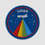 An round embroidered patch with a dark blue background and a red ring just inside the border. At the top is the word LIDAR in white, with a small white plane just beneath it and tiny white stars on either side. Beaming out of the bottom of the plane in roughly triangular shape are blocks of (from left) red, yellow, green, and lighter blue.
