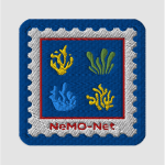 A square embroidered patch with rounded edges. The border is dark blue, with a white square inside with scalloped edges like a postage stamp, and the words NeMO-Net in red. Inside the white is a blue square with four squiggly shapes like coral, in (clockwise from top left) yellow, green, yellow, and blue.