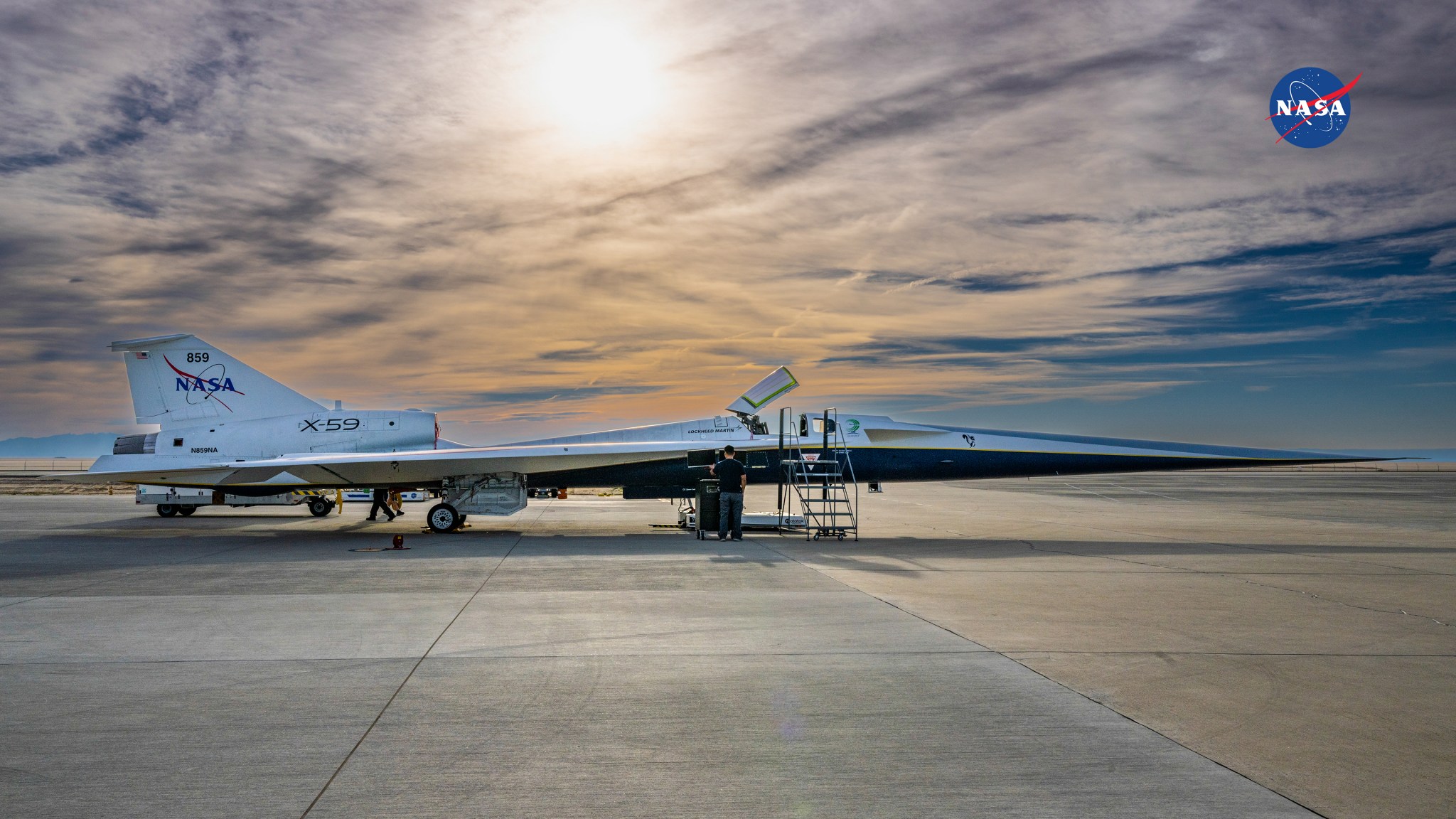NASA’s X-59 is pictured on the ramp under a cloudy sky.