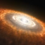 This is an artist’s impression of a young star surrounded by a protoplanetary disk. Darker rings in the disk are where objects like planetesimals are forming, clearing a path through the debris.