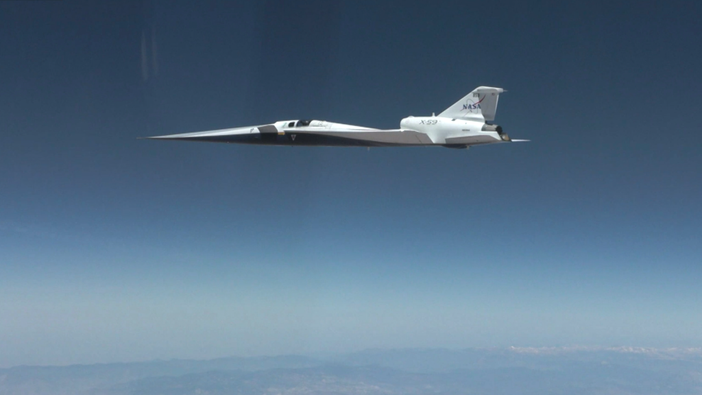 NASA’s X-59 quiet supersonic research aircraft flies above the clouds during its first supersonic flight. The aircraft is shown in side profile during level flight with desert and mountain terrain visible below.